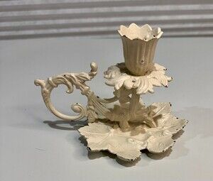 vintage ornate metal candlestick holder with a shabby chic white painted finish